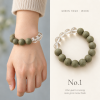 Green Hour · Worn No.1 — on the wrist A wrist wearing an olive-green incense bead bracelet with clear quartz, beside it laid flat