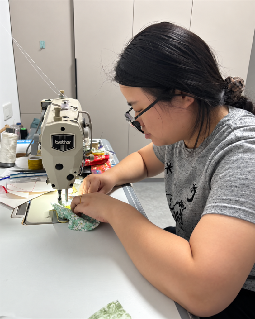 Wang Dan, ZendoDream sachet maker, sewing a fabric pouch at a white sewing machine